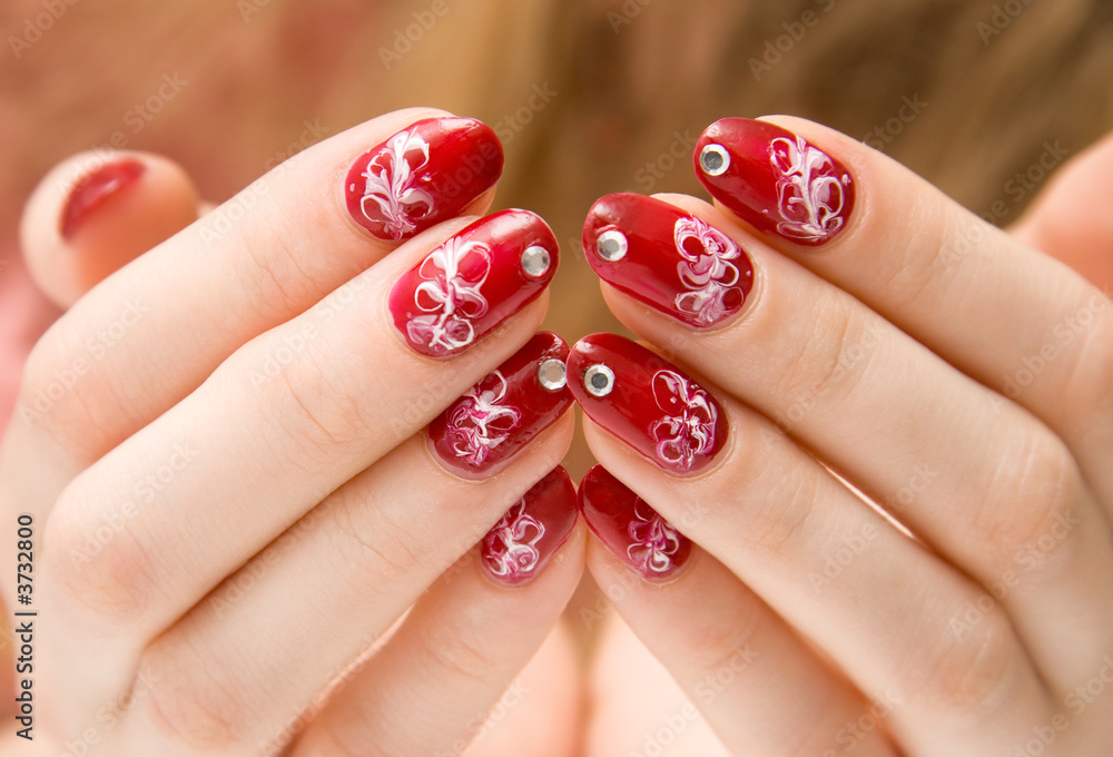 Red woman nails with decorations.
