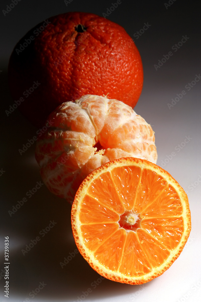Tangerine fruit in dark light detail view