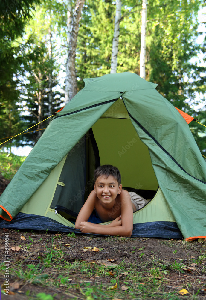happy boy in camping tent