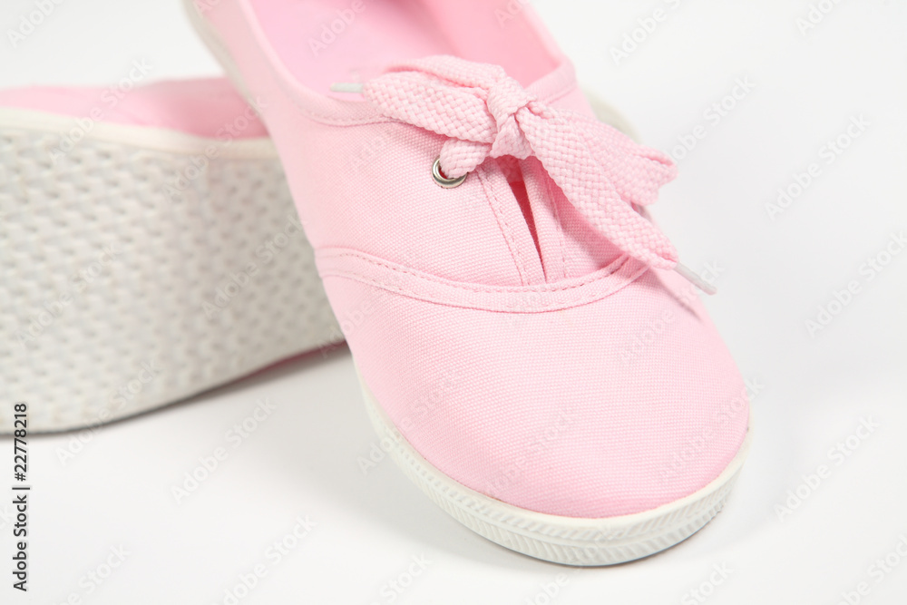 a pair of pink women shoes and white background