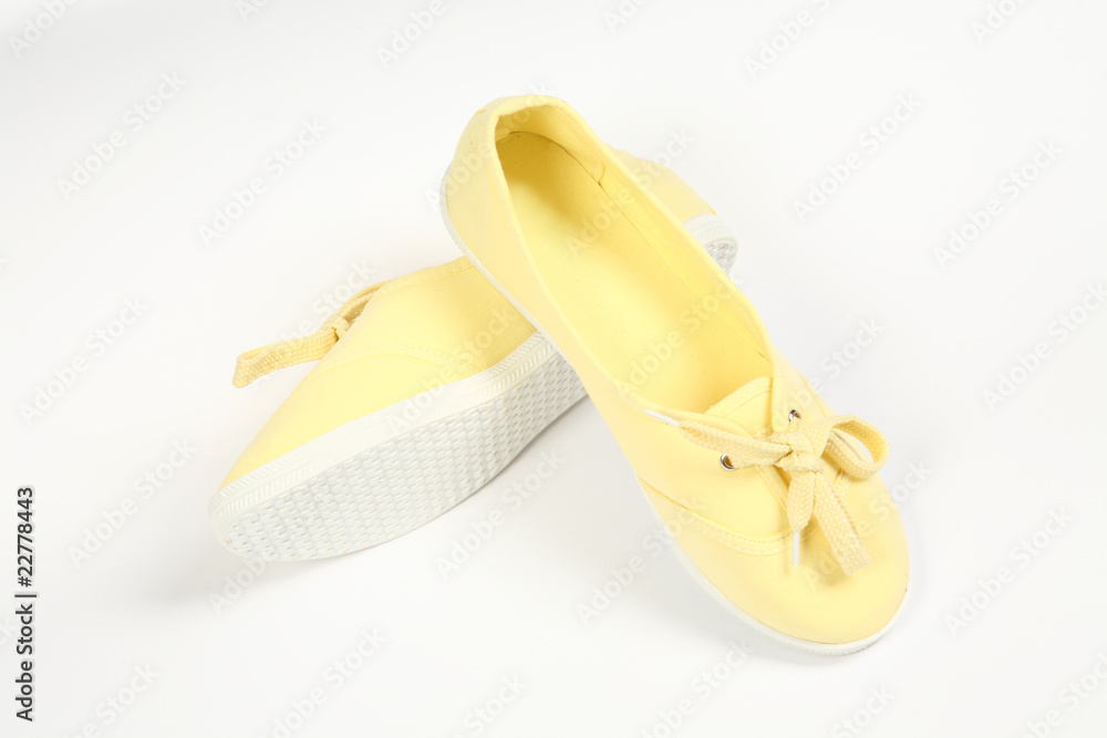 a pair of yellow women shoes and white background