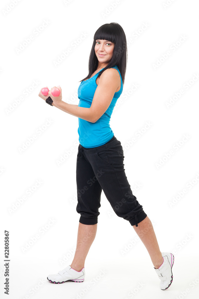 Young positive woman holing dumbbells