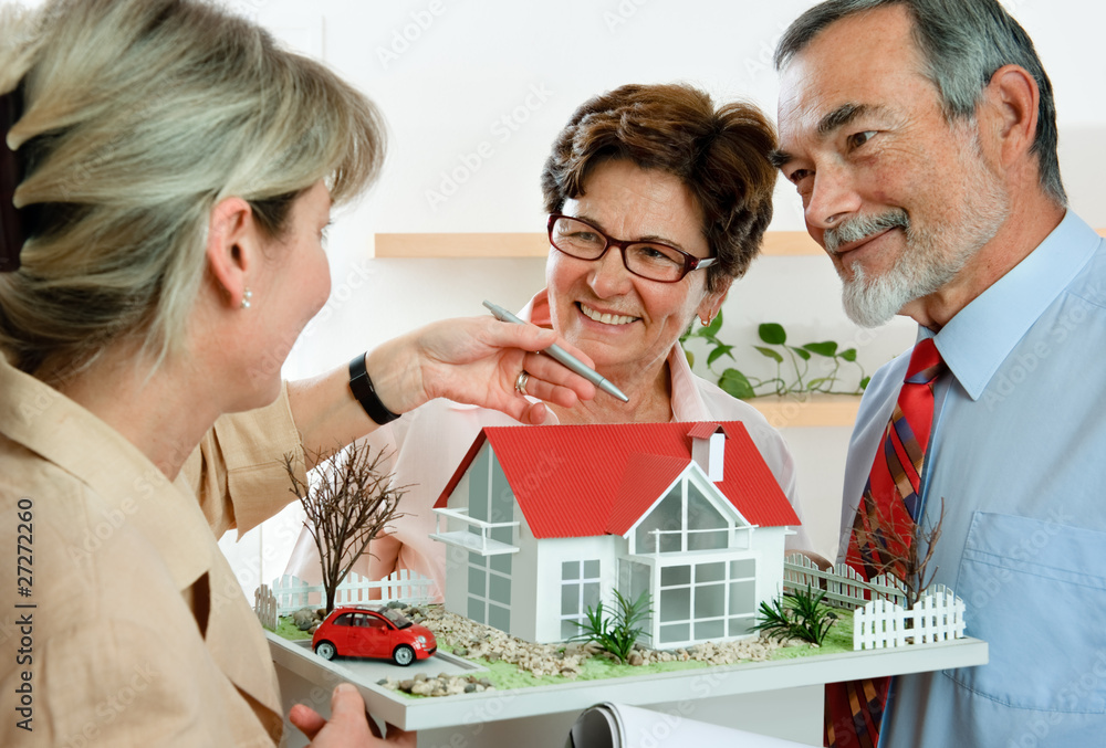 Couple discussing  with real estate agent or architect