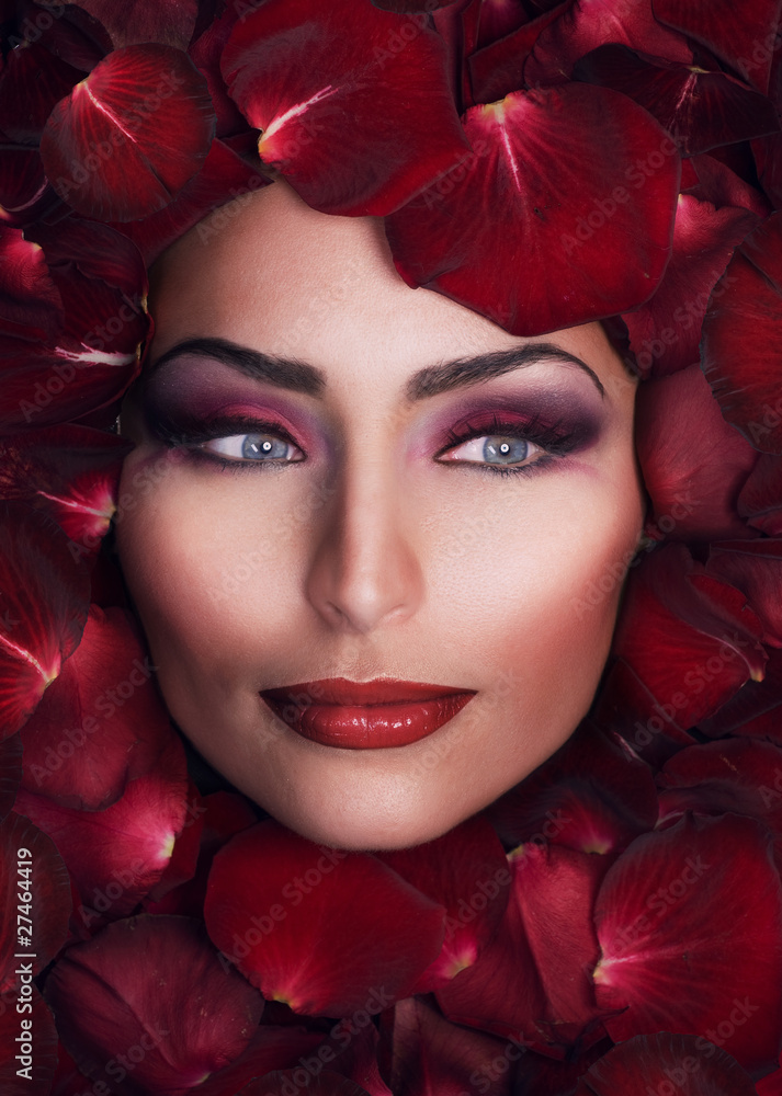 Beautiful Womans Face and rose petals.Perfect Skin
