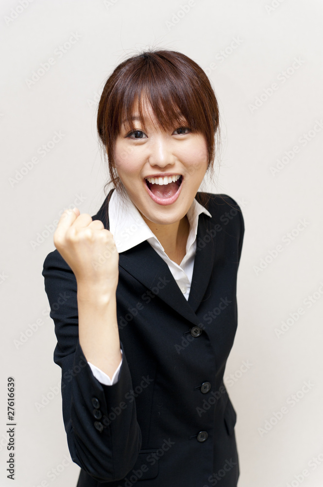 a portrait of young business woman cheering