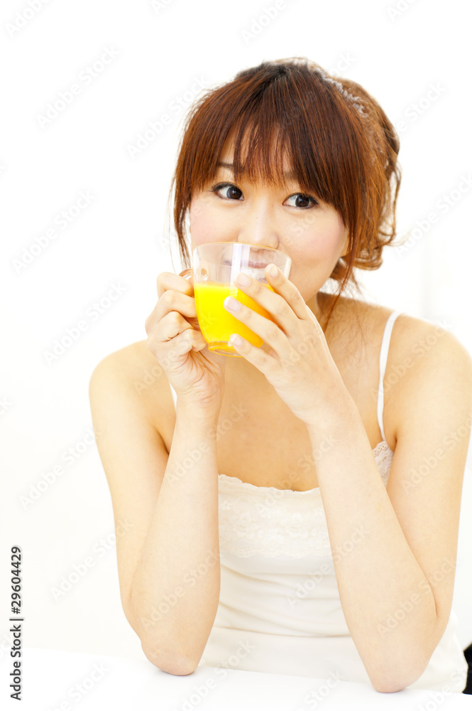 a portrait of beautiful asian woman taking a orange juice