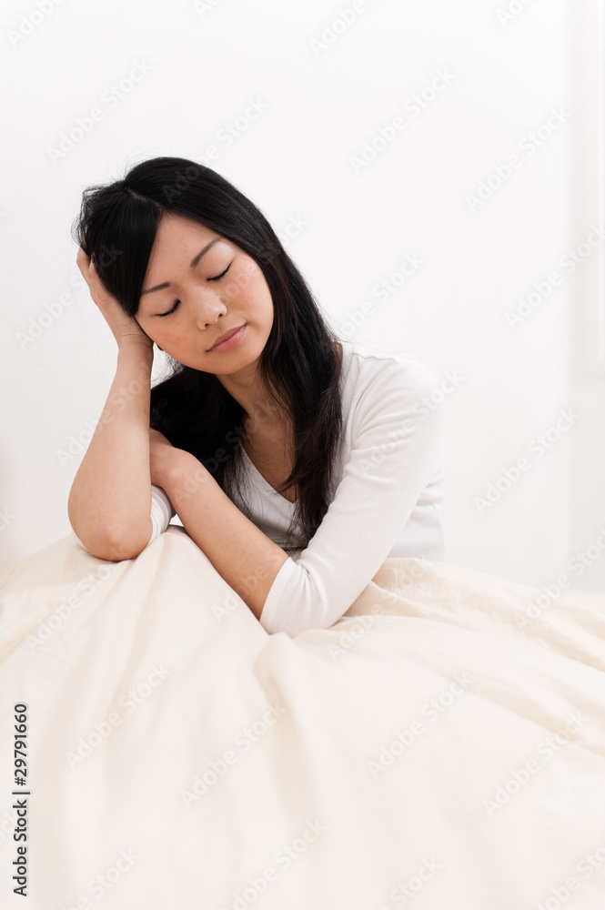 a portrait of beautiful asian woman on the bed