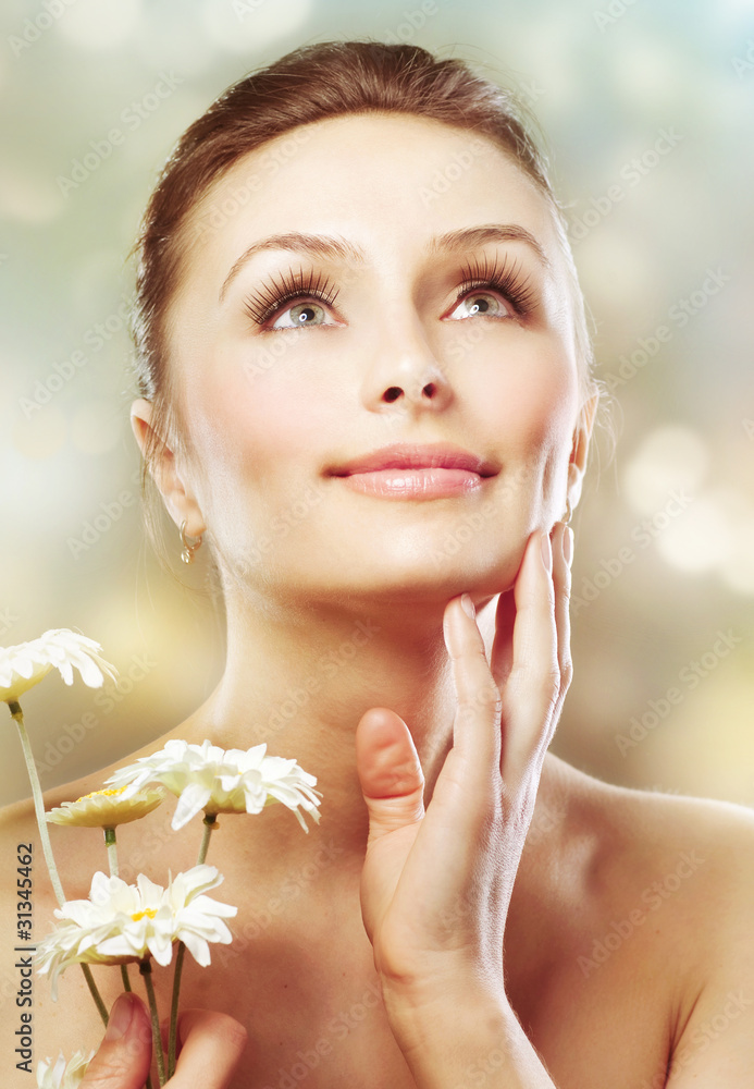 Beautiful Spring Woman with flowers. Skincare concept