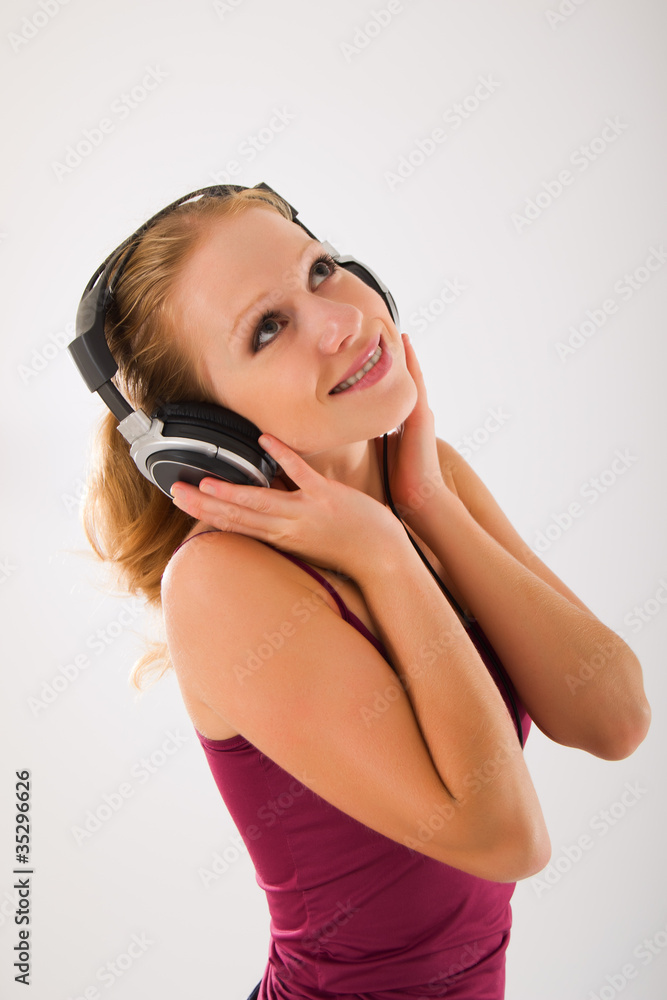 happy attractive girl in headphones listens to music