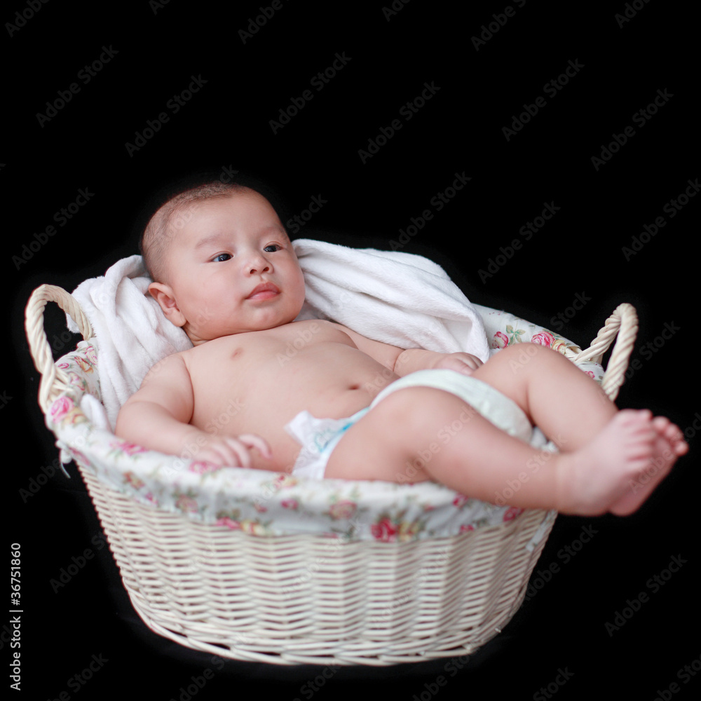 cute baby in  basket with black background