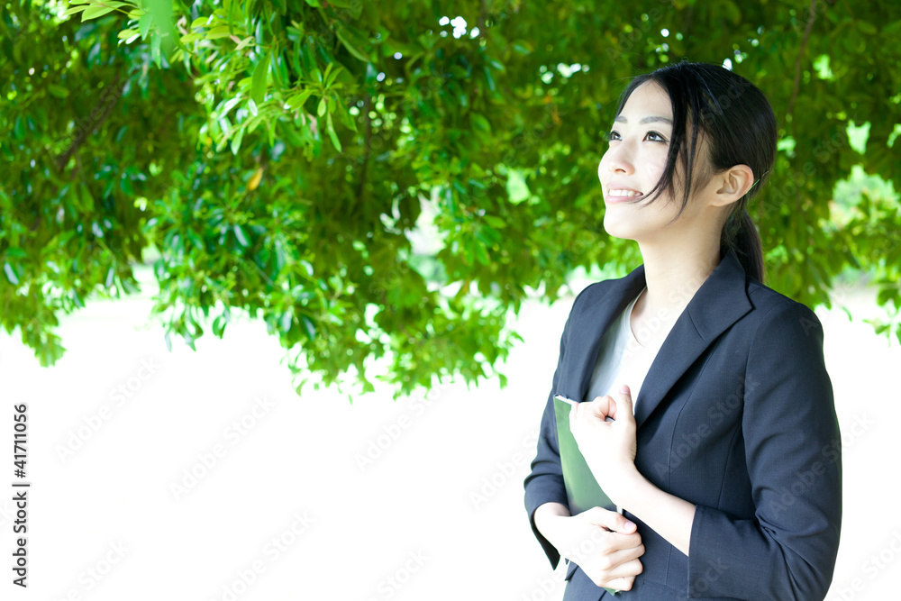 asian businesswoman relaxing in the park