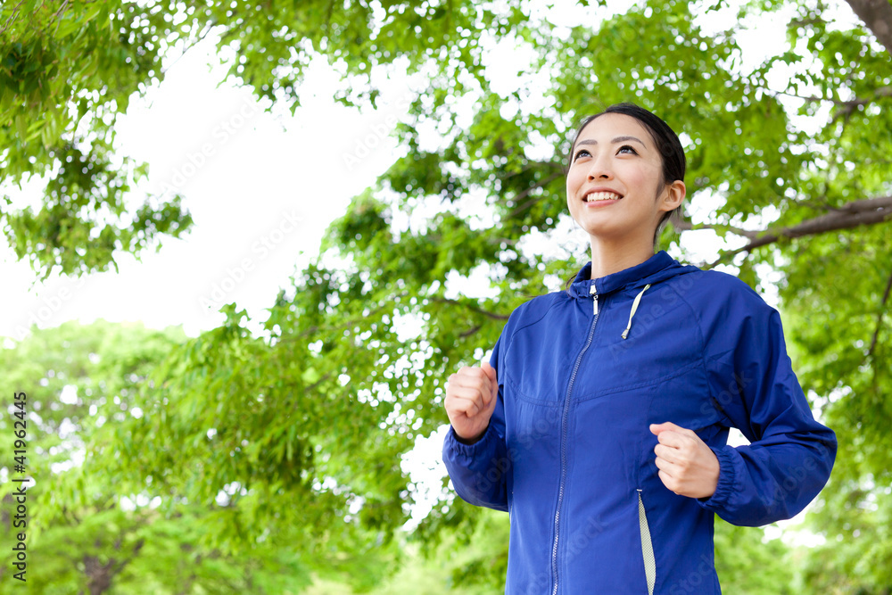 young asian woman running in the park