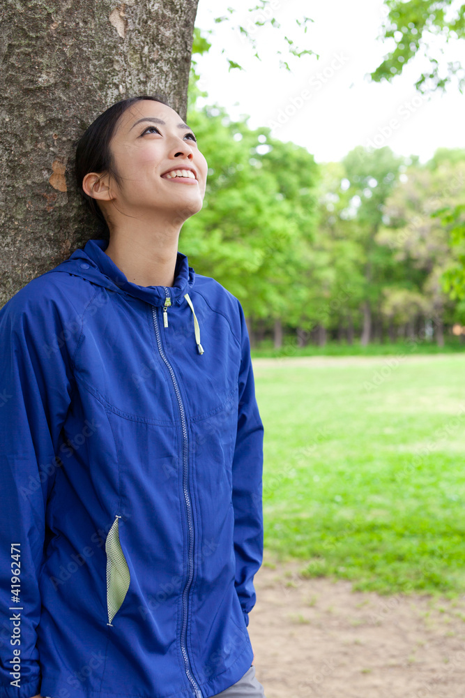 年轻的亚洲女人在公园里放松