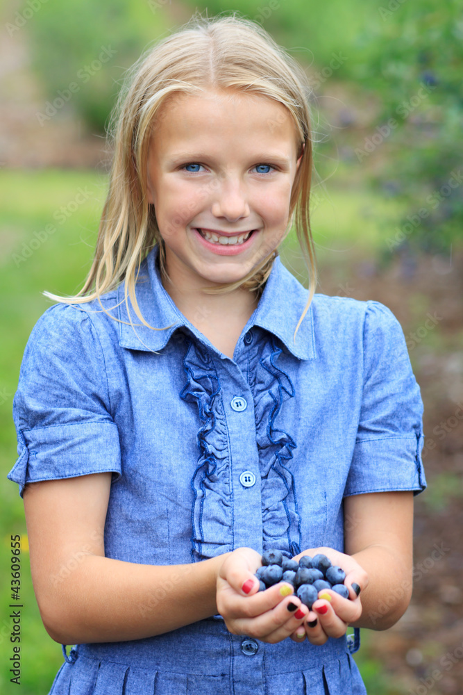 Blonde Girl with Fresh Picked Blueberries Smiling