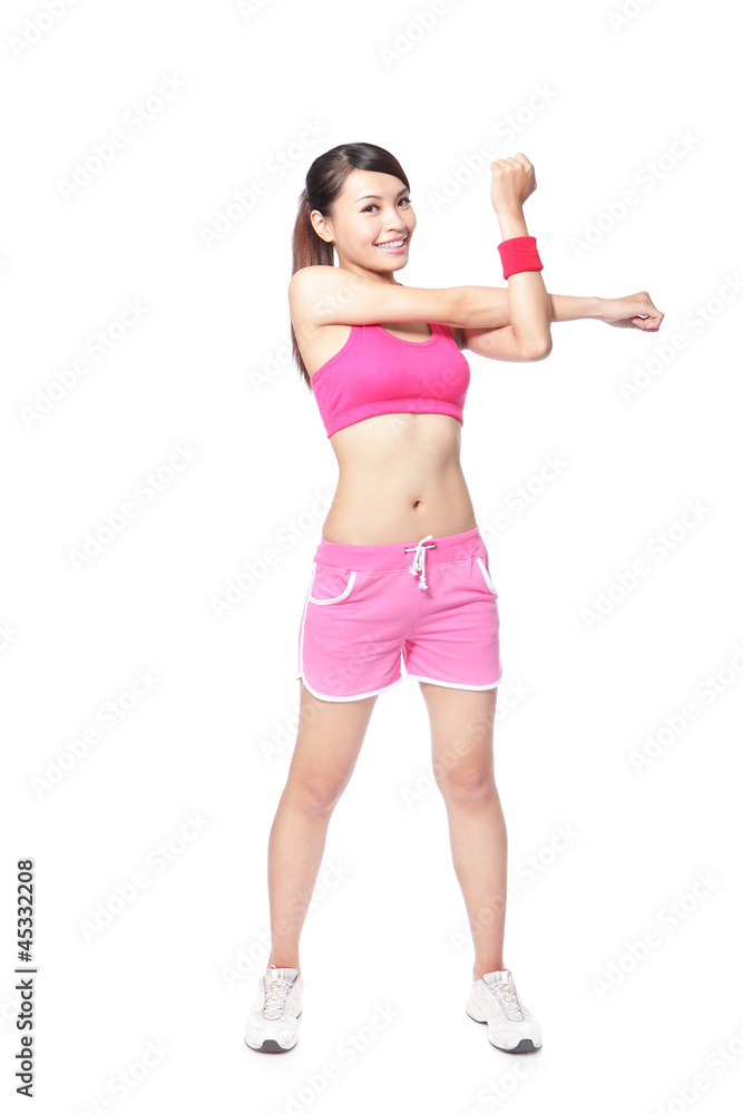 Fit woman stretching her arm to warm up