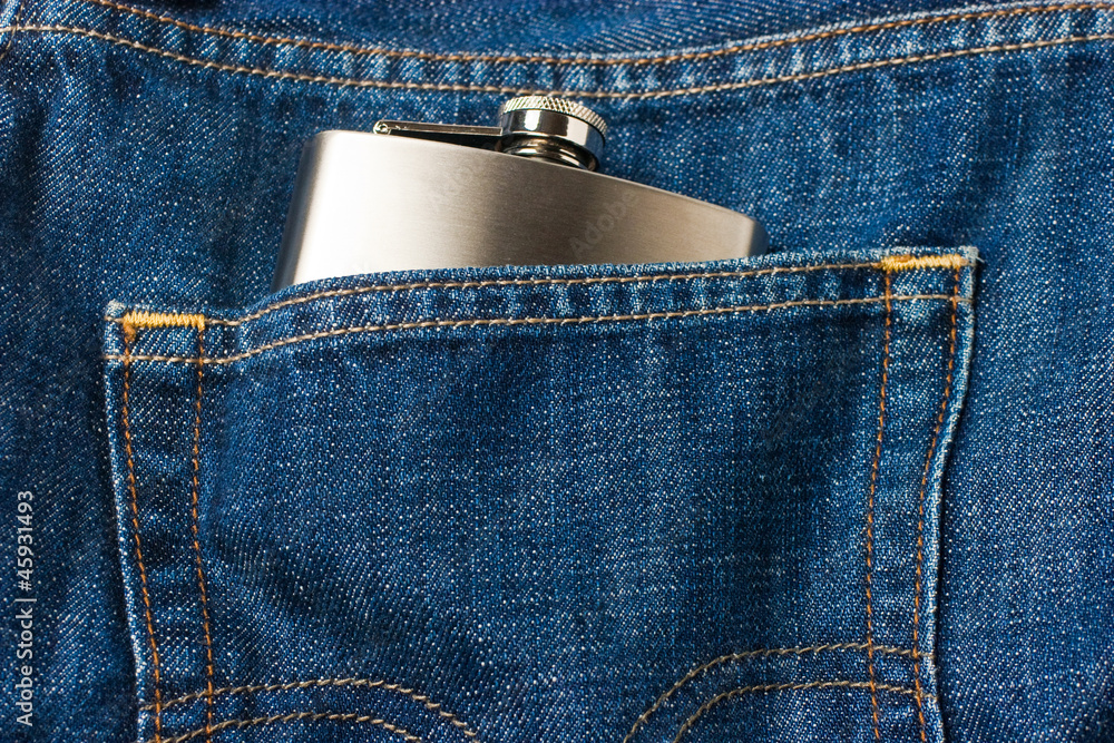 Blue jeans pocket with bottle of alcohol