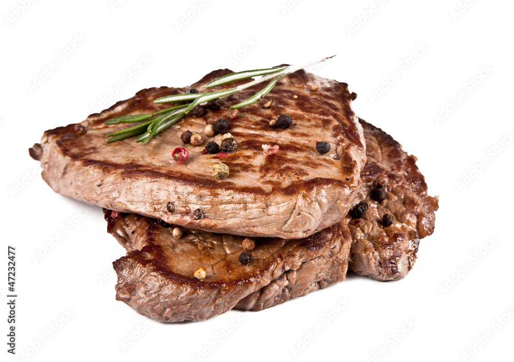 Delicious beef steaks isolated on white background