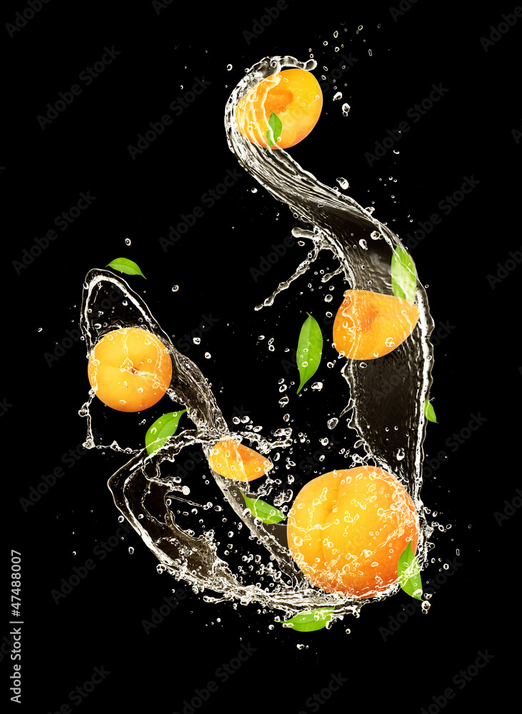 Apricots in water splash, isolated on black background