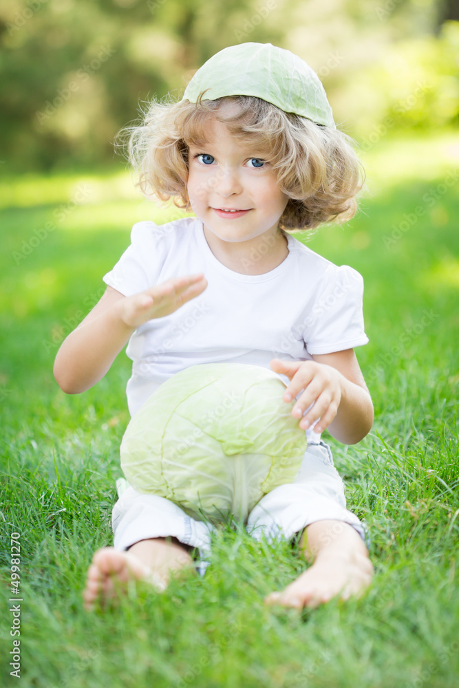Child with white cabbage