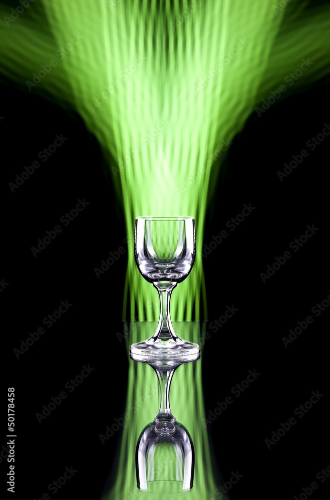 Glass of alcohol on disco background, party