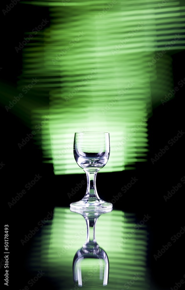 Glass of alcohol on disco background, party