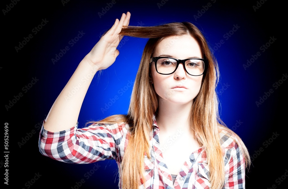 Girl with nerd glasses holding her hair