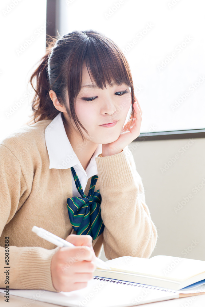 a young asian school girl studying