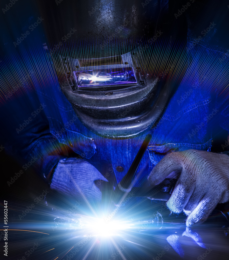 Worker welding the steel part
