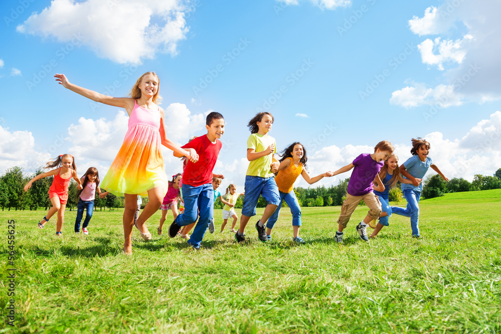 Large group of kids running in the park