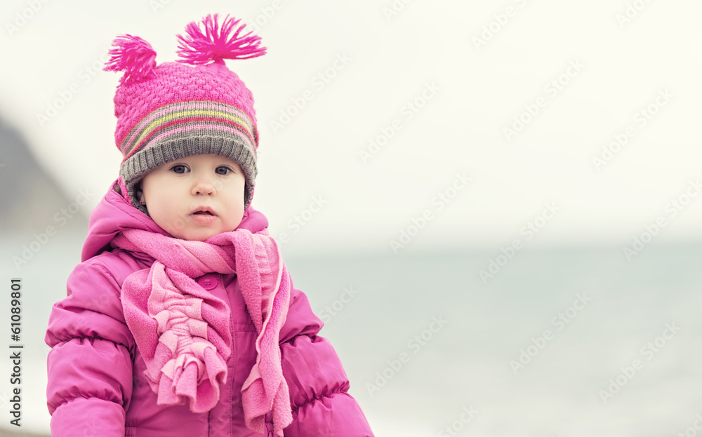 baby girl in a pink hat and scarf