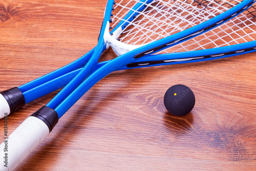 Close up of a squash rackets and balls