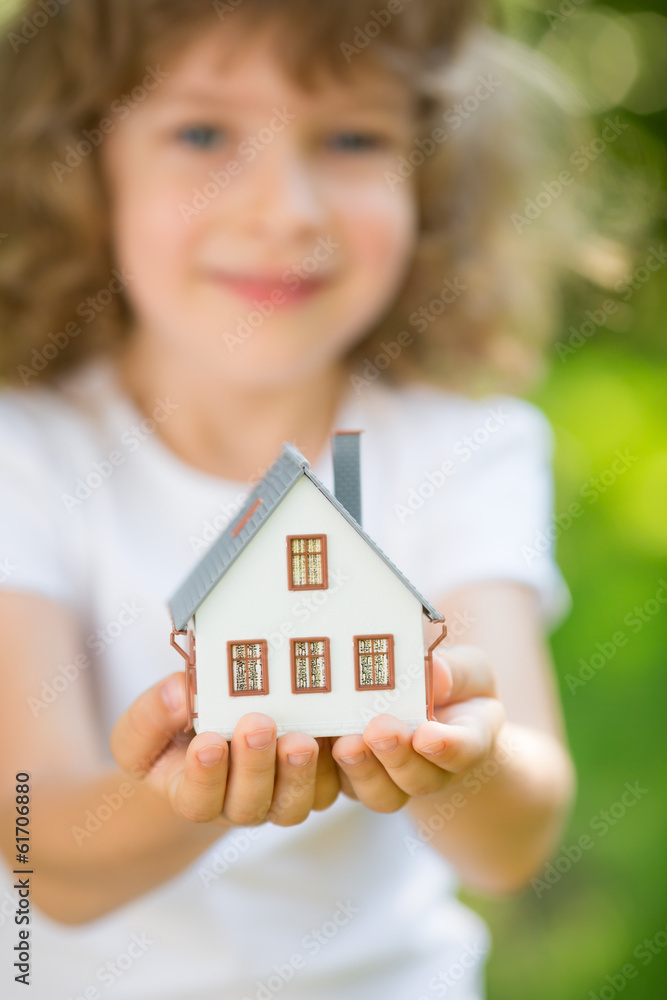Child holding house