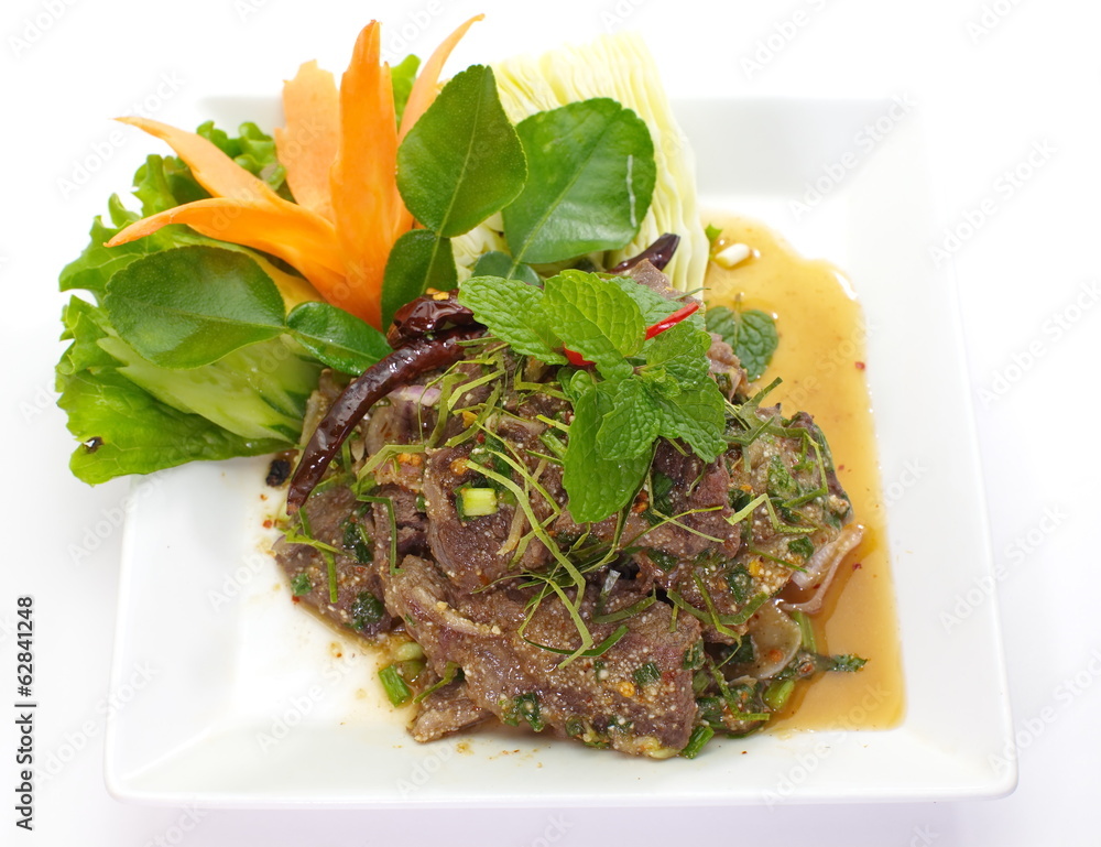Spicy salad with pork and green herb in Thai style