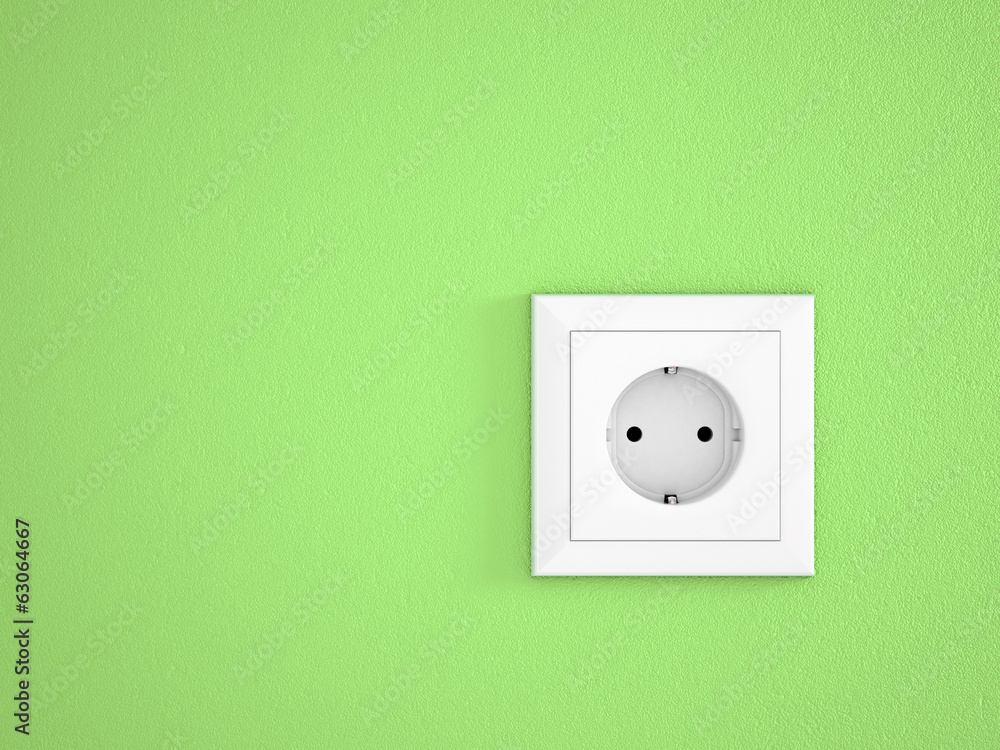 simple white electric socket on green wall