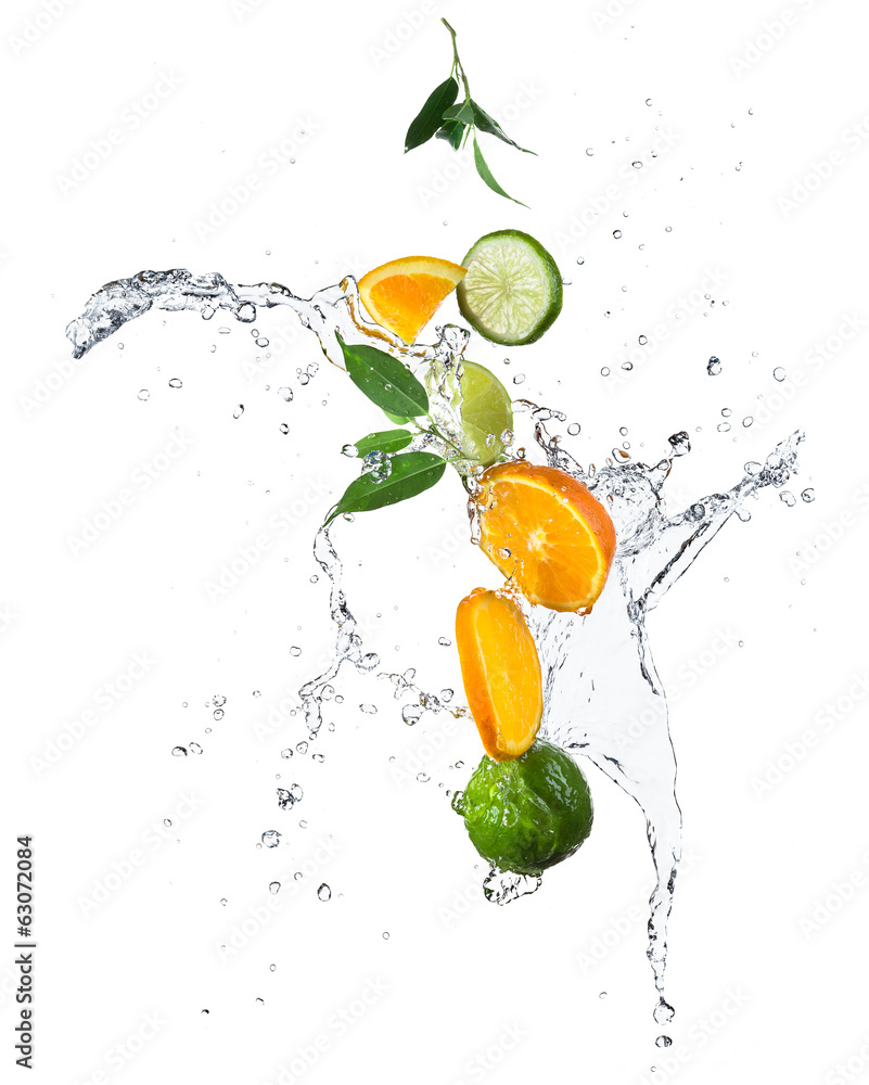 Pieces of oranges and limes in water splash