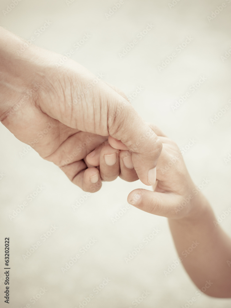Mother holding a hand of child