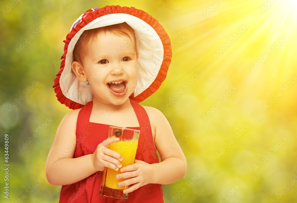baby girl drinking orange juice in the summer