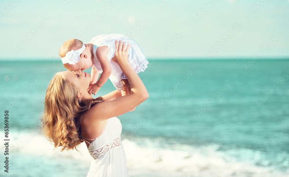 happy family in white dress. Mother throws up baby in the sky