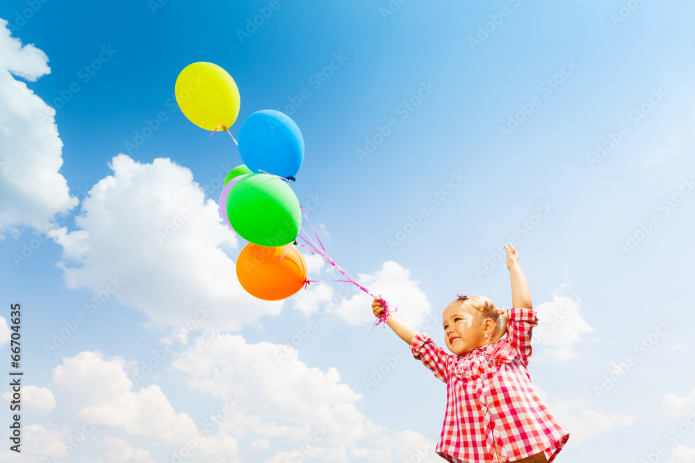 Cute girl with many balloons on sky background
