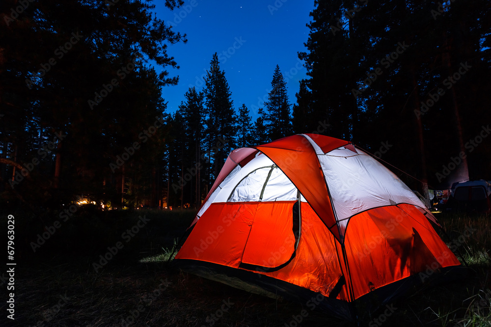 Campsite with illuminated tent