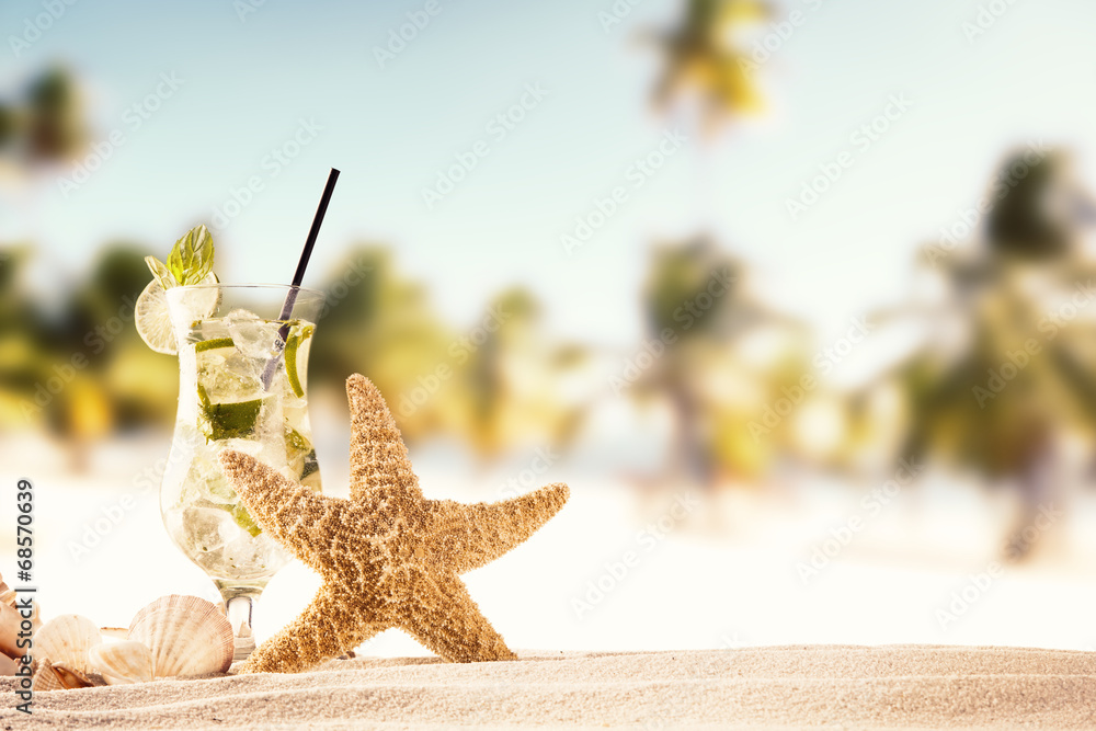 Summer beach with drink and shells