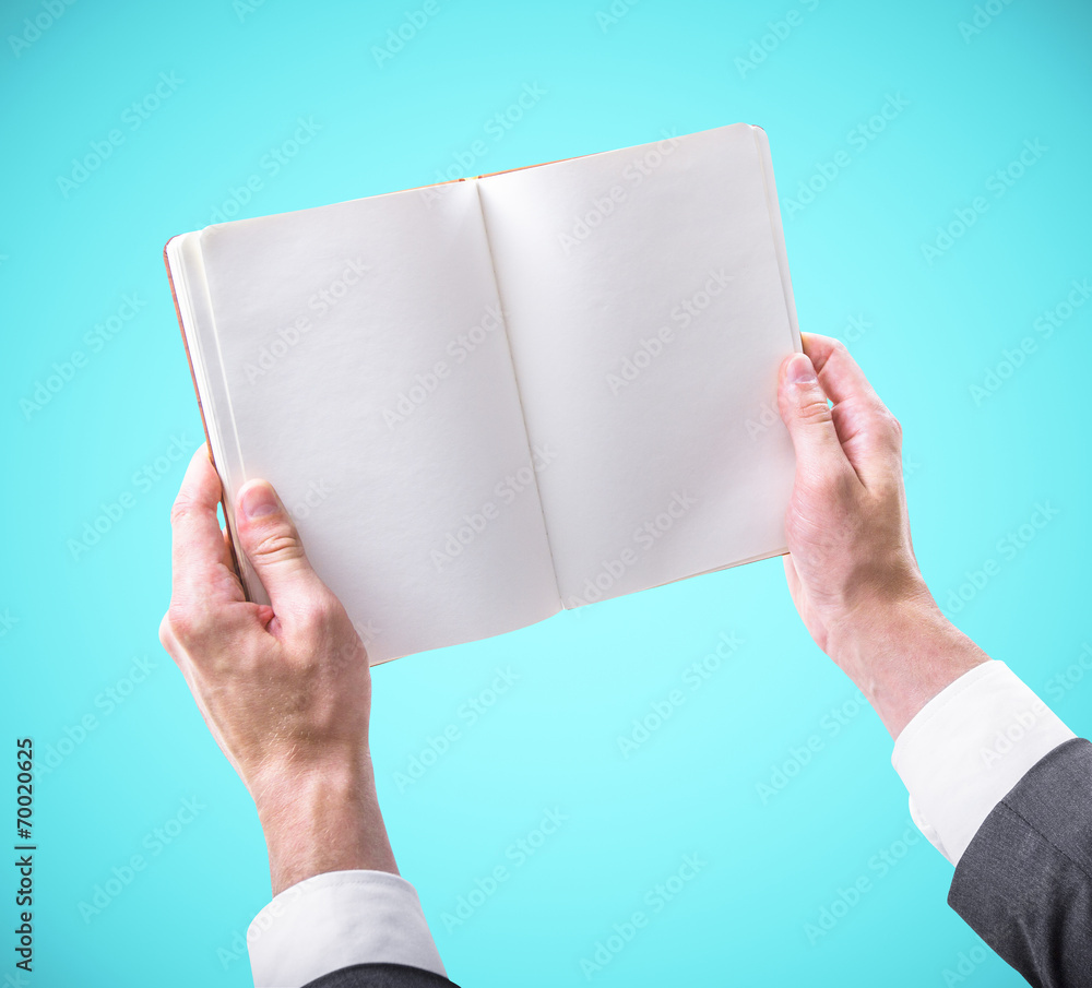 hands holding a blank book