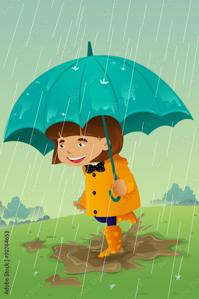 Girl with umbrella and raincoat playing in the mud