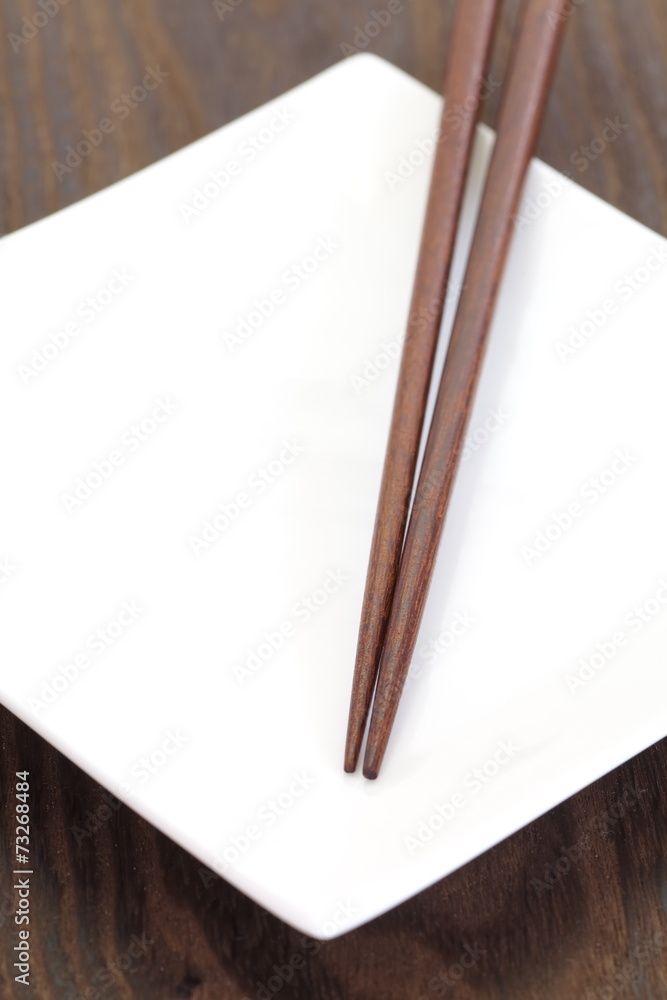 亚洲餐桌白盘子棕色木筷子