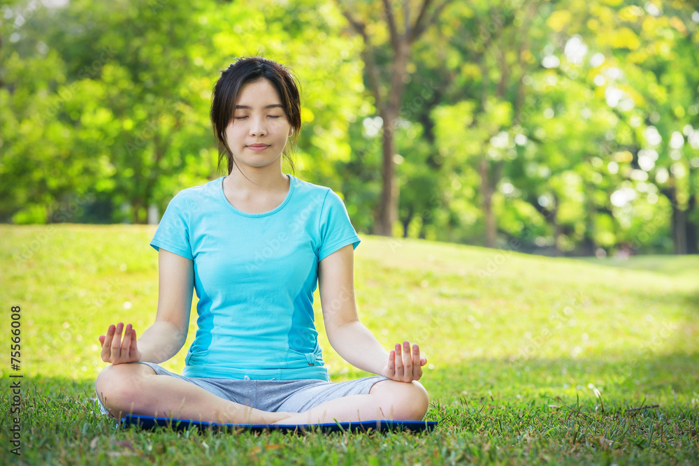 Young Woman doing Yoga Exercises Outdoor