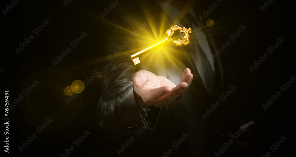 businessman hold a gold shining key, business concept