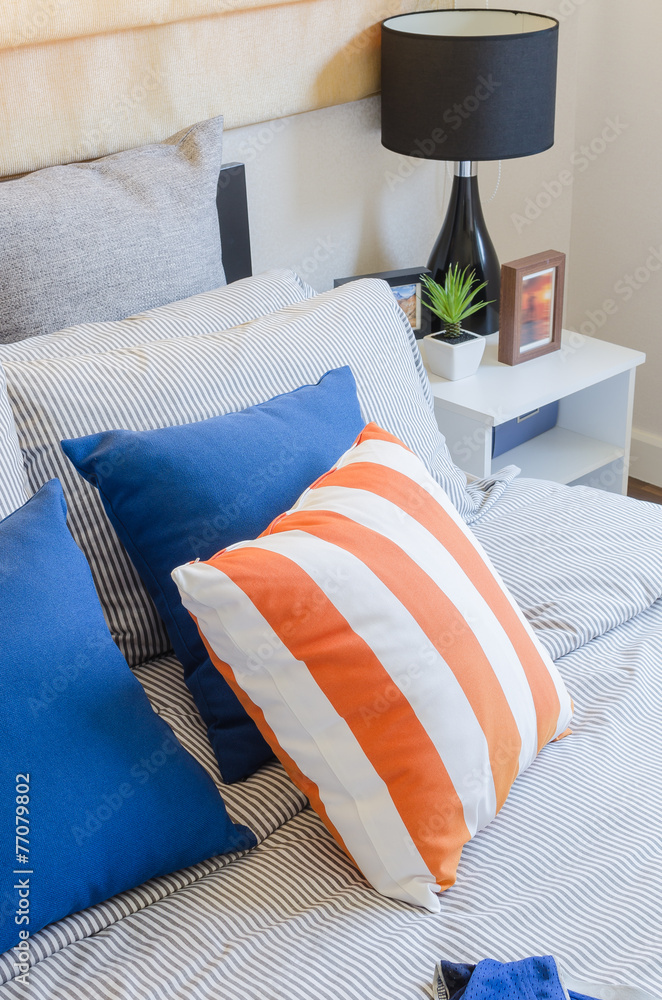 床上的橙色和蓝色枕头