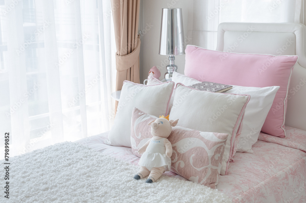 kids bedroom with doll on bed in pink color style