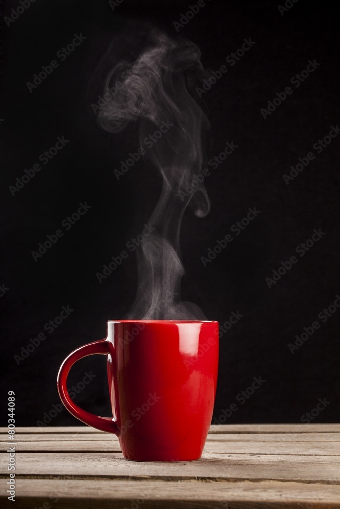 Aroma. Steaming coffee cup on dark background