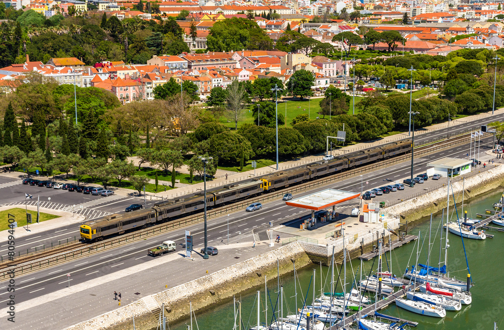 Suburban train passing by a street of Lisbon - Portugal